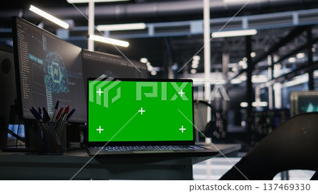 Chroma key laptop and desktop PC used for visualizing AI workloads and inspecting server room layout. Green screen notebook supporting artificial intelligence systems through simulated computing tasks 137469330