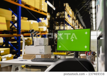 Empty warehouse with mockup display on computer monitor, ideal for logistics or tracking software or e-commerce dashboards. Surrounded by shelves, racks and boxes for order processing. Empty warehouse with mockup display on computer monitor, ideal for logistics or tracking software or e-commerce dashboards. Surrounded by shelves, racks and boxes for order processing. 137469338