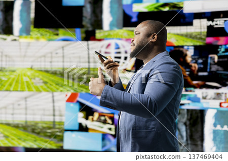 African american person uses a phone call connection to showcase engagement and online communication through mobile high tech platforms. Online interaction through social networks apps. African american person uses a phone call connection to showcase engagement and online communication through mobile high tech platforms. Online interaction through social networks apps. 137469404