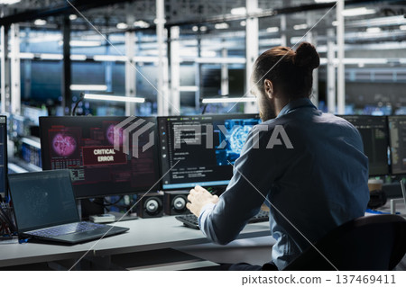 Data center computer scientist trying to fix malfunctions using AI program. Server hub IT professional using machine learning to optimize system health, repairing critical error 137469411