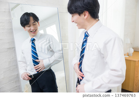 A young man looking at a mirror A young man looking at a mirror 137469763