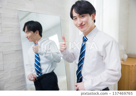 A young man looking at a mirror A young man looking at a mirror 137469765