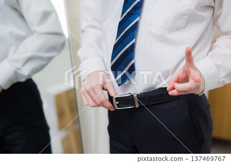 A young man looking at a mirror 137469767