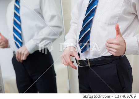 A young man looking at a mirror A young man looking at a mirror 137469769