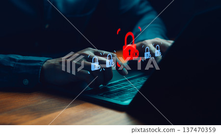 Cybersecurity concept showing person using laptop computer with digital padlock icons, highlighting data protection, secure access, privacy risk prevention, and online security awareness. 137470359
