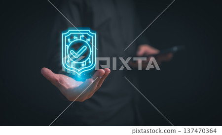 Cybersecurity protection concept with a glowing digital shield and checkmark floating above a hand, symbolizing data security, system protection, secure access, and trusted digital technology. Cybersecurity protection concept with a glowing digital shield and checkmark floating above a hand, symbolizing data security, system protection, secure access, and trusted digital technology. 137470364