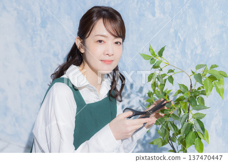 A woman with a smile wearing an apron A woman with a smile wearing an apron 137470447