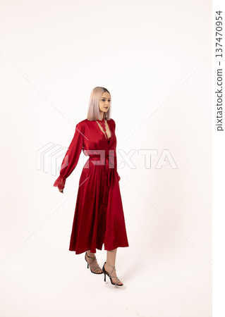 Woman in red robe standing on white background 137470954