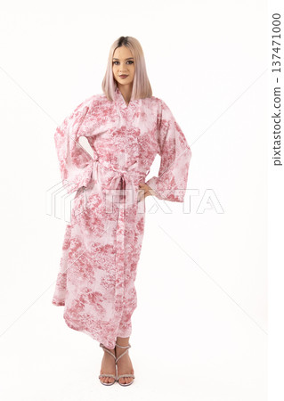 Young woman in pink robe looking at camera 137471000