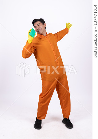 Happy cleaner in orange uniform dancing with a mop Happy cleaner in orange uniform dancing with a mop 137471014