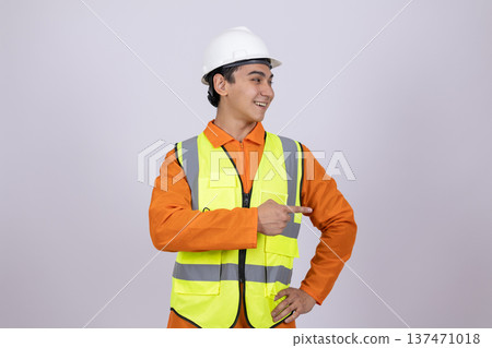 Construction worker in safety vest with hands on hips Construction worker in safety vest with hands on hips 137471018