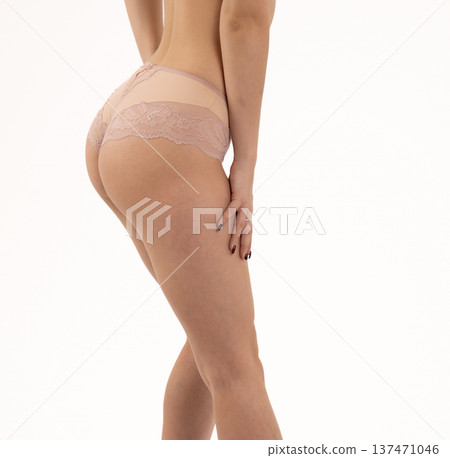 Side view of woman in beige underwear set 137471046