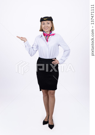 Flight attendant in uniform gesturing to the side Flight attendant in uniform gesturing to the side 137471111
