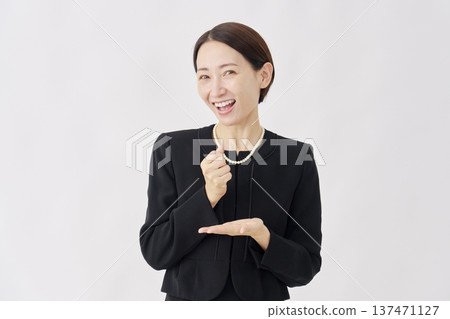 Woman in fluttering mourning clothes, white background, looking at camera 137471127