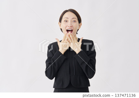 一位身著喪服、面帶微笑、略顯驚訝的女子，白色背景，正看向鏡頭。 137471136