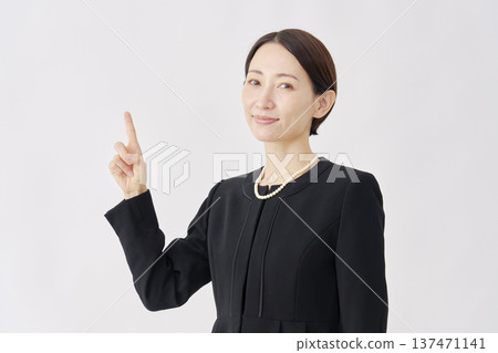 Woman in mourning clothes pointing to the left, white background Woman in mourning clothes pointing to the left, white background 137471141