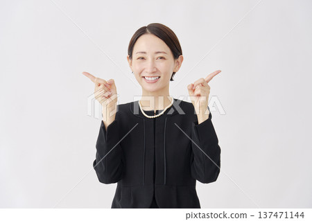 Woman in mourning clothes pointing left and right, white background Woman in mourning clothes pointing left and right, white background 137471144