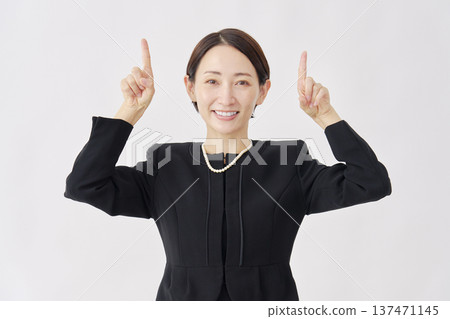 Woman in mourning clothes pointing up, white background Woman in mourning clothes pointing up, white background 137471145