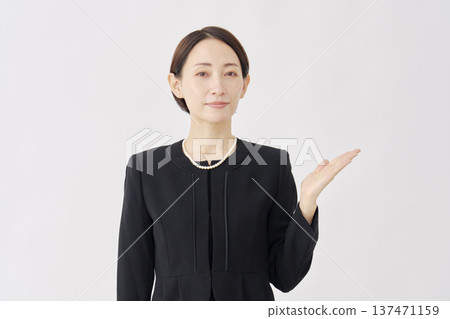 Woman in mourning clothes pointing to the right, white background Woman in mourning clothes pointing to the right, white background 137471159