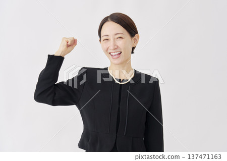 Woman in mourning clothes, fist pump, white background Woman in mourning clothes, fist pump, white background 137471163