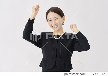 Woman in mourning clothes, fist pump, white background 137471164