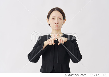Woman in mourning clothes making a cross gesture on a white background Woman in mourning clothes making a cross gesture on a white background 137471165