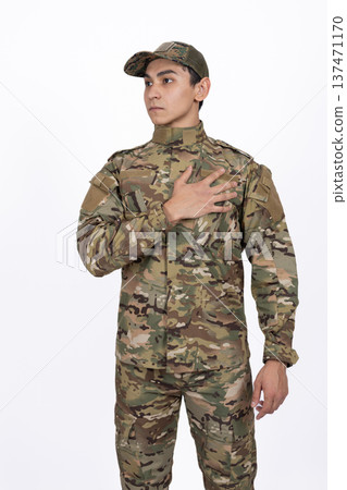 Soldier in camouflage uniform with hand on his heart Soldier in camouflage uniform with hand on his heart 137471170