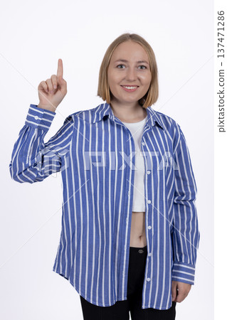 Young woman pointing finger up having an idea Young woman pointing finger up having an idea 137471286