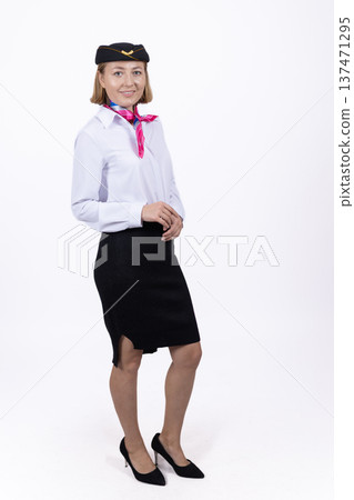 Stewardess in uniform posing on white background Stewardess in uniform posing on white background 137471295