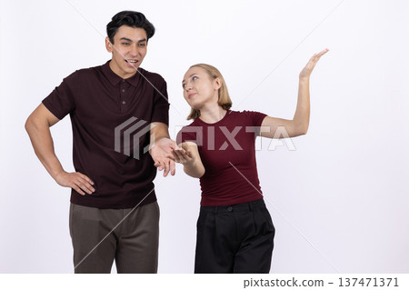 Young woman in dark clothes whispering a secret to a man Young woman in dark clothes whispering a secret to a man 137471371