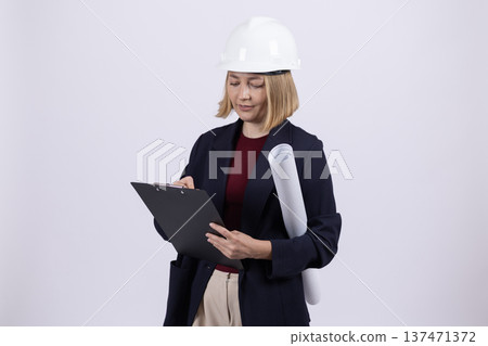 Female manager in dark suit holding a digital tablet in studio Female manager in dark suit holding a digital tablet in studio 137471372