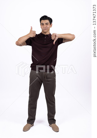 Young man pointing down with both hands 137471373