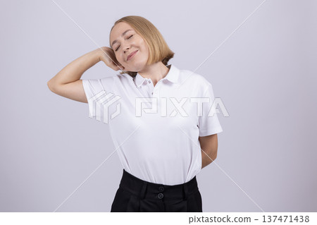 Young woman in white shirt posing on white background Young woman in white shirt posing on white background 137471438