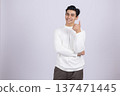 Man in white shirt pointing up with one finger in studio 137471445