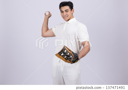 Young man holding a baseball ball and wearing glove 137471491