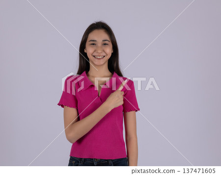 Happy young woman in pink t-shirt pointing at herself 137471605