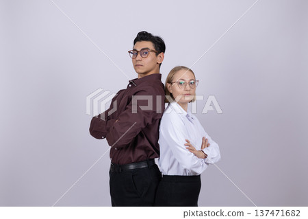 Professional male and female engineers standing back to back Professional male and female engineers standing back to back 137471682