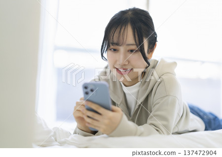 Young woman looking at smartphone screen 137472904