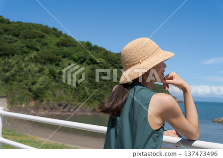 A young woman looking at the sea A young woman looking at the sea 137473496