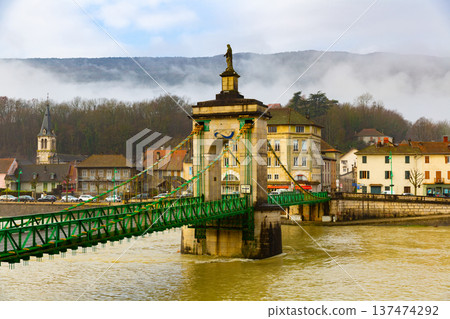 Suspension bridge across Rhone river and embankment of Seyssel in winter 137474292