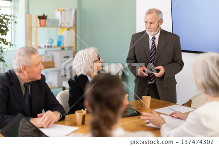 Elderly man presenting with remote control 137474302