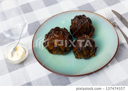 Delicious roasted artichokes served with garlic aioli sauce Delicious roasted artichokes served with garlic aioli sauce 137474357