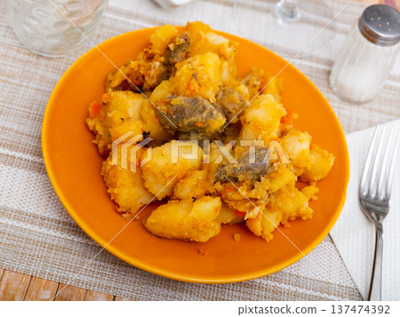 Portion of braised potatoes with beef Portion of braised potatoes with beef 137474392