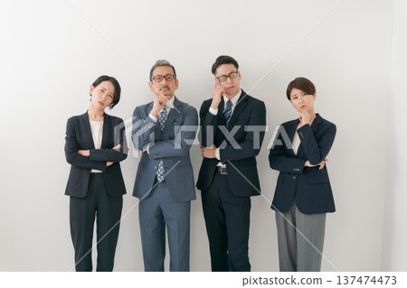 Four businessmen with worried expressions Four businessmen with worried expressions 137474473