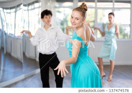 Happy girl an boy dancing foxtrot in choreographic studio Happy girl an boy dancing foxtrot in choreographic studio 137474576