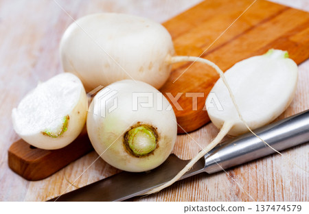 Whole and halved white radishes Whole and halved white radishes 137474579