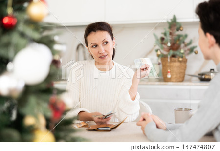 Mom gives pocket money to teenage boy before celebrating Christmas Mom gives pocket money to teenage boy before celebrating Christmas 137474807