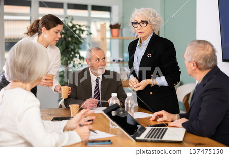 Female leader, trainer talking to group of people, brainstorming, discussing ideas in auditory Female leader, trainer talking to group of people, brainstorming, discussing ideas in auditory 137475150