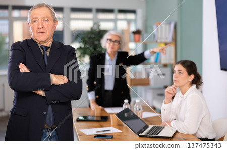 Elderly woman scolds elderly man in office Elderly woman scolds elderly man in office 137475343