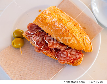 Sandwich with delicious delicaty dried sausage Fuet 137475389
